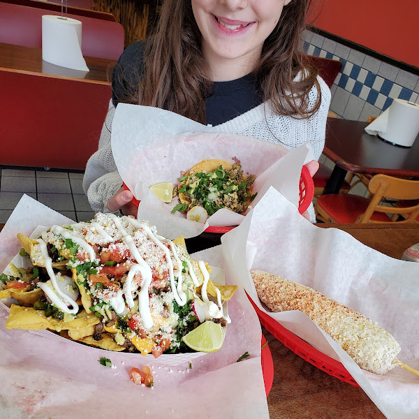 Supreme Nachos, street corn, chicken taco