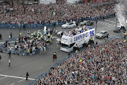 Real Madrid players celebrate with their fans at the Plaza Cibeles in Madrid, Spain on April 30 2022 after winning the Spanish LaLiga title.