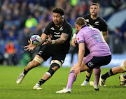 Ardie Savea of New Zealand off loads the ball during the Autumn International match against Scotland at Murrayfield Stadium on November 13, 2022 in Edinburgh, Scotland.