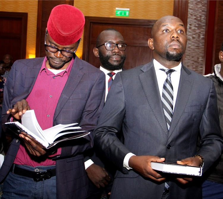 Didmus Barasa and Kipchumba Murkomen with copies of the book