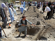 Afghan men dig grave during a mass funeral after a suicide bomb blast at a wedding in Kabul, Afghanistan August 18, 2019. suicide 