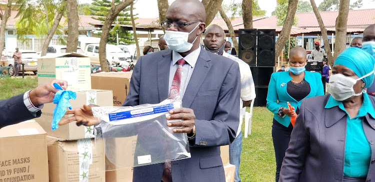 Siaya Governor Cornel Rasanga receives PPE at Siaya County Referral Hospital on Monday.