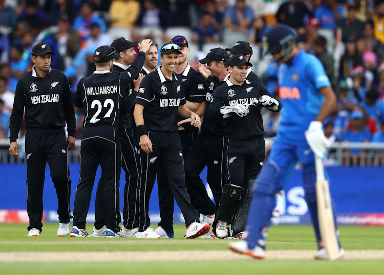 New Zealand players celebrate after taking a wicket during their Cricket World Cup semi-final match against India at Old Trafford in Manchester on July 10 2019.