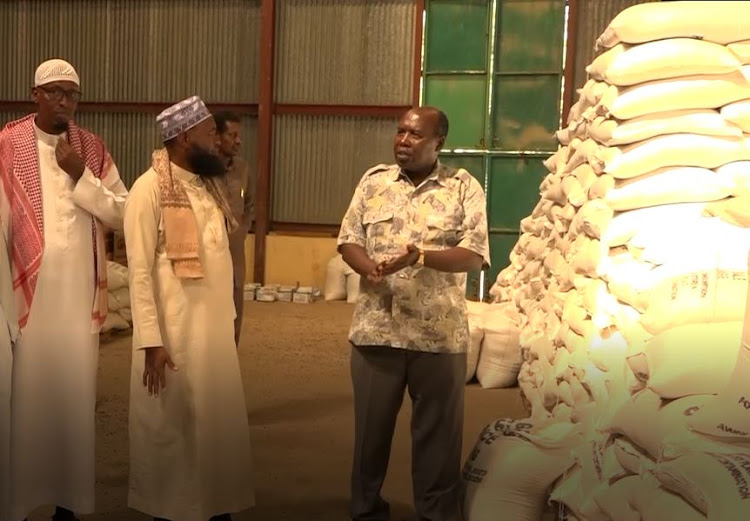 Garissa County commissioner Boaz Cherutich with Muslim clerics after the the relief food distribution.