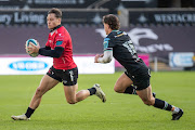 Jack Walsh of Ospreys attempts to chase down Quan Horn of the Lions during the United Rugby Championship match in Swansea earlier this season. Horn should be available for the Lions' next match against Cardiff.