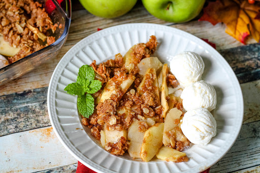 Apple Crisp on a plate with ice cream.