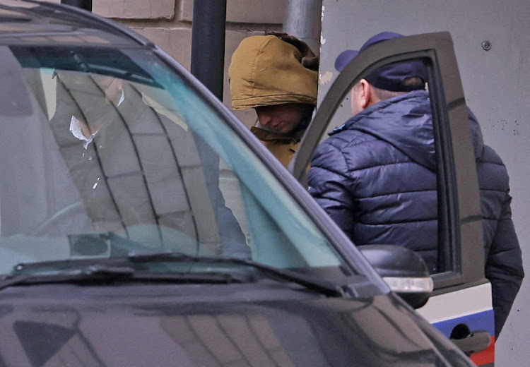 Wall Street Journal reporter Evan Gershkovich is escorted from a court building in Moscow, Russia, March 30 2023. Picture: EVGENIA NOVOZHENINA/REUTERS