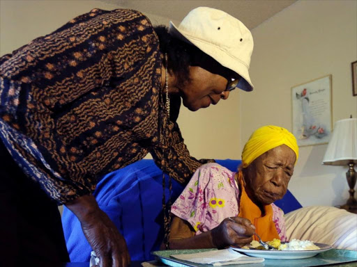 Lois Judge, left, helps her aunt Susannah Mushatt Jones, during breakfast in Jones' room at the Vandalia Avenue Houses, in the Brooklyn borough of New York. Jones, the world’s oldest person, has died in New York at age 116 in June 22, 2015. Photo/COURTESY