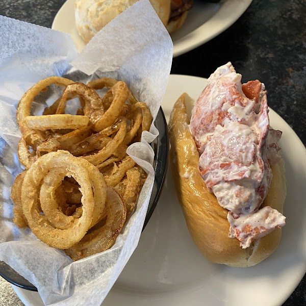 Gluten free onion rings and lobster roll on a gf roll.