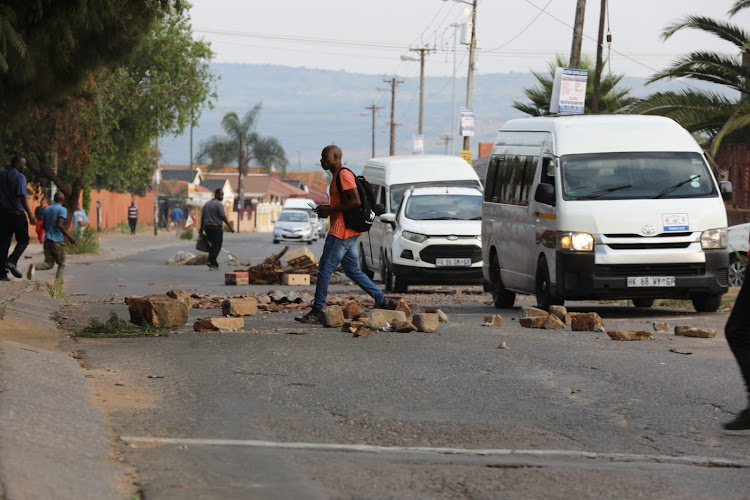 It's business as usual in Atteridgeville as some of the drivers and road users navigate roads strewn with rocks as the national shutdown called by the EFF unfolds.