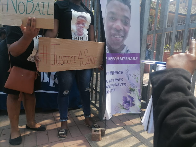 Family and friends of Sihle Mtshare, whose body was found in a drain, hold a demonstration outside the Pinetown magistrate's court on Wednesday.