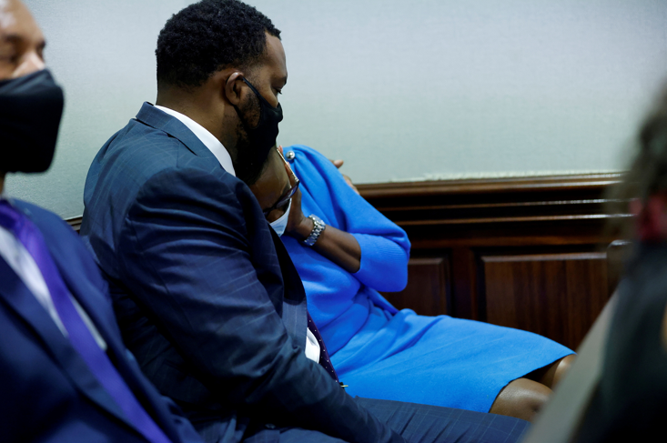 Ahmaud Arbery's mother Wanda Cooper reacts next to her attorney Lee Merritt during the trial of William "Roddie" Bryan, Travis McMichael and Gregory McMichael, who are charged with the February 2020 death of 25-year-old Arbery, at the Gwynn County Superior Court, in Brunswick, Georgia, US on November 5, 2021.