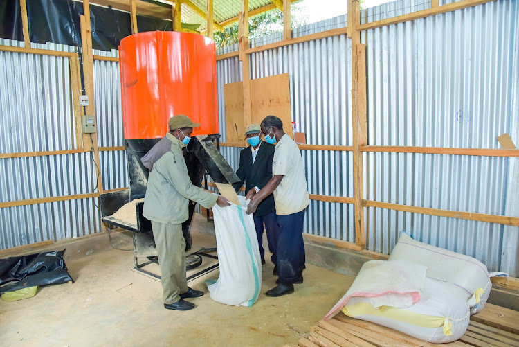 Members of the ACK Thaita Men's Welfare Group at the animal feeds manufacturing plant in Kirinyaga Central Constituency.