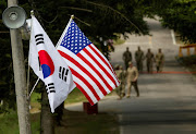 The South Korean and US flags fly next to each other at Yongin, South Korea, on August 23 2016. 