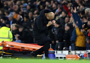 Manchester City manager Pep Guardiola celebrates his  side's third goal scored by Kevin De Bruyne during a Premier League match against Leeds United at Etihad Stadium on December 14 2021 in Manchester, England.