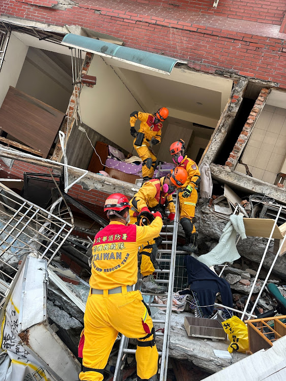 Firefighters work at the site where a building collapsed following the earthquake, in Hualien, Taiwan, in this handout provided by Taiwan's National Fire Agency on April 3, 2024. Taiwan National Fire Agency/Handout