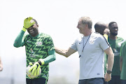 Bafana Bafana goalkeeper Itumeleng Khune and head coach Stuart Baxter share some light moments during the national men's team training session at Steyn City School on November 13, 2018 in Johannesburg