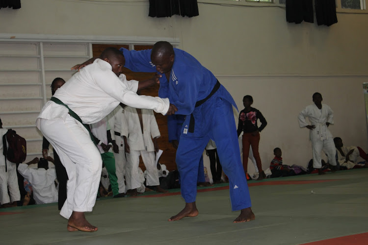 Denis Mwangi (R) engages John Kamau in men U-90kg bout during the second Ambassadors Cup on November 7, 2019 at the Japanese School, Nairobi.