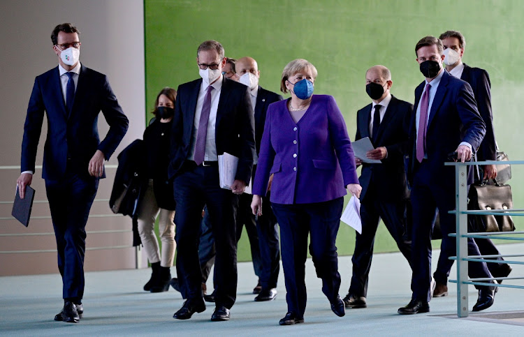 North Rhine-Westphalia premier Hendrik Wuest, Berlin mayor Michael Mueller, German Chancellor Angela Merkel and her designated successor Olaf Scholz arrive to address a news conference in Berlin, Germany, December 2 2021. Picture: JOHN MACDOUGAL/REUTERS