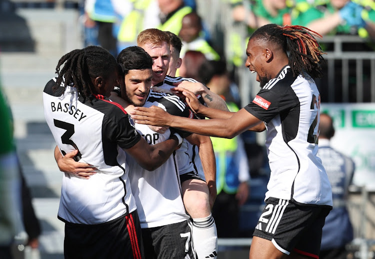 Raul Jimenez celebrates scoring Fulham's third goal with teammates in their Premier League win against Luton Town at Kenilworth Road in Luton on Sunday.