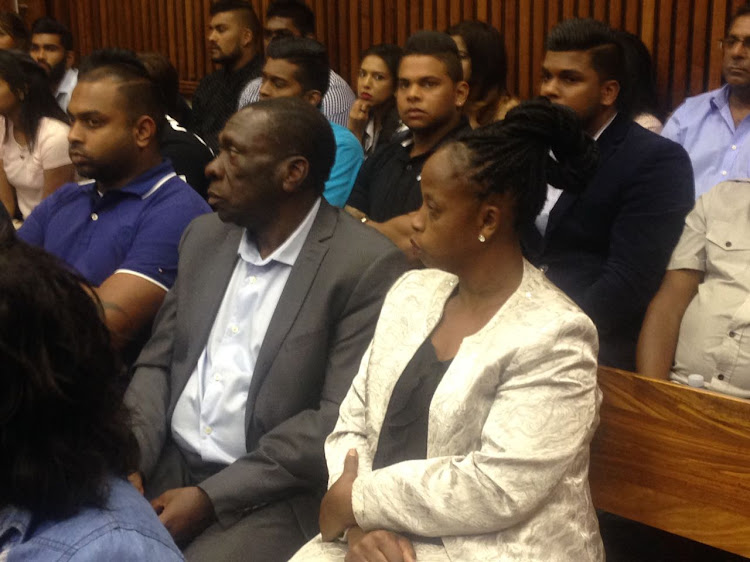 Simba Mhere's parents Angela and Joseph seated next to family members and friends of Preshalin Naidoo,the man accused of causing Simba's death.