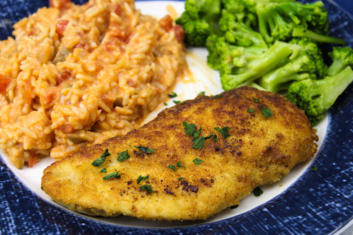 Parmesan Crusted Chicken With Creamy Risotto on a plate.