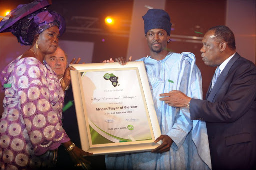 In this file photo CAF President Issa Hayatou (R) and FIFA President Sepp Blatter (2L) watches Alice Emiola (L) hold the CAF certificate awarded to her son, Emmanuel Adebayor (C) after being crowned African Footballer of the Year at the Confederation of African Football (CAF) awards ceremony in Lagos on February 10, 2009. Emmanuel Adebayor has accused his mother of practising witchcraft on him and kicked her out of her home in Togo.