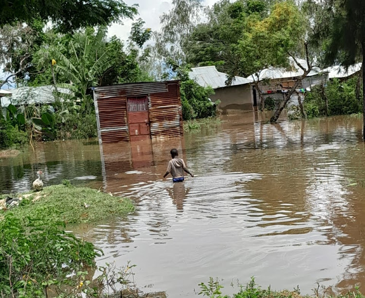 A child wades through waters in Dunga, Kisumu Central sub-county.