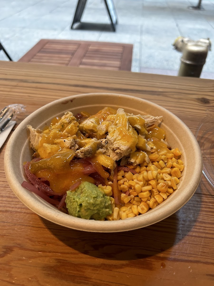 Hungry Bowl (roasted chicken, brown rice, avocado, pickled red onions, corn, beans, mango chutney, tortilla chips & spicy mango dressing)