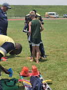 Herco Radley gives his prize to another competitor, who tripped at the end of their 150m hurdles race.