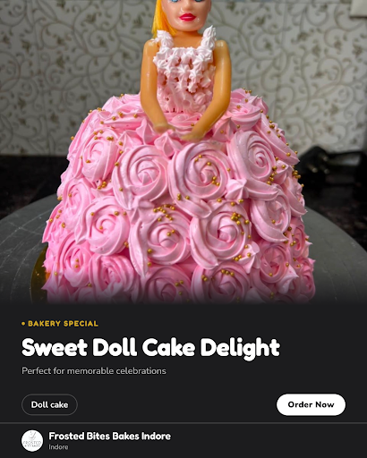 Frosted Bites Bakes Indore offers a charming doll-shaped pink cake, perfect for celebrations. Cra… post image