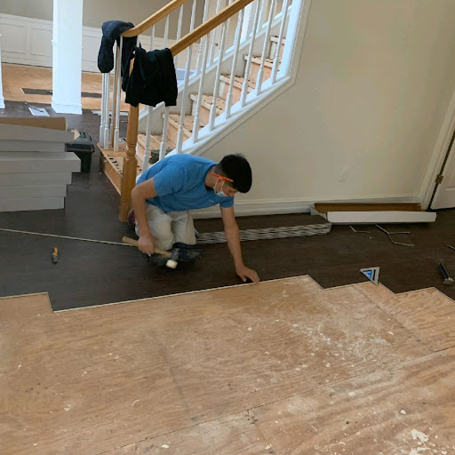 Planks being installed beside a stair opening in an owned Final Floors photo.