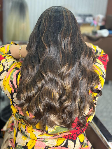 long layered waves with highlights. This style involves cutting the hair in varying lengths to cr… post image