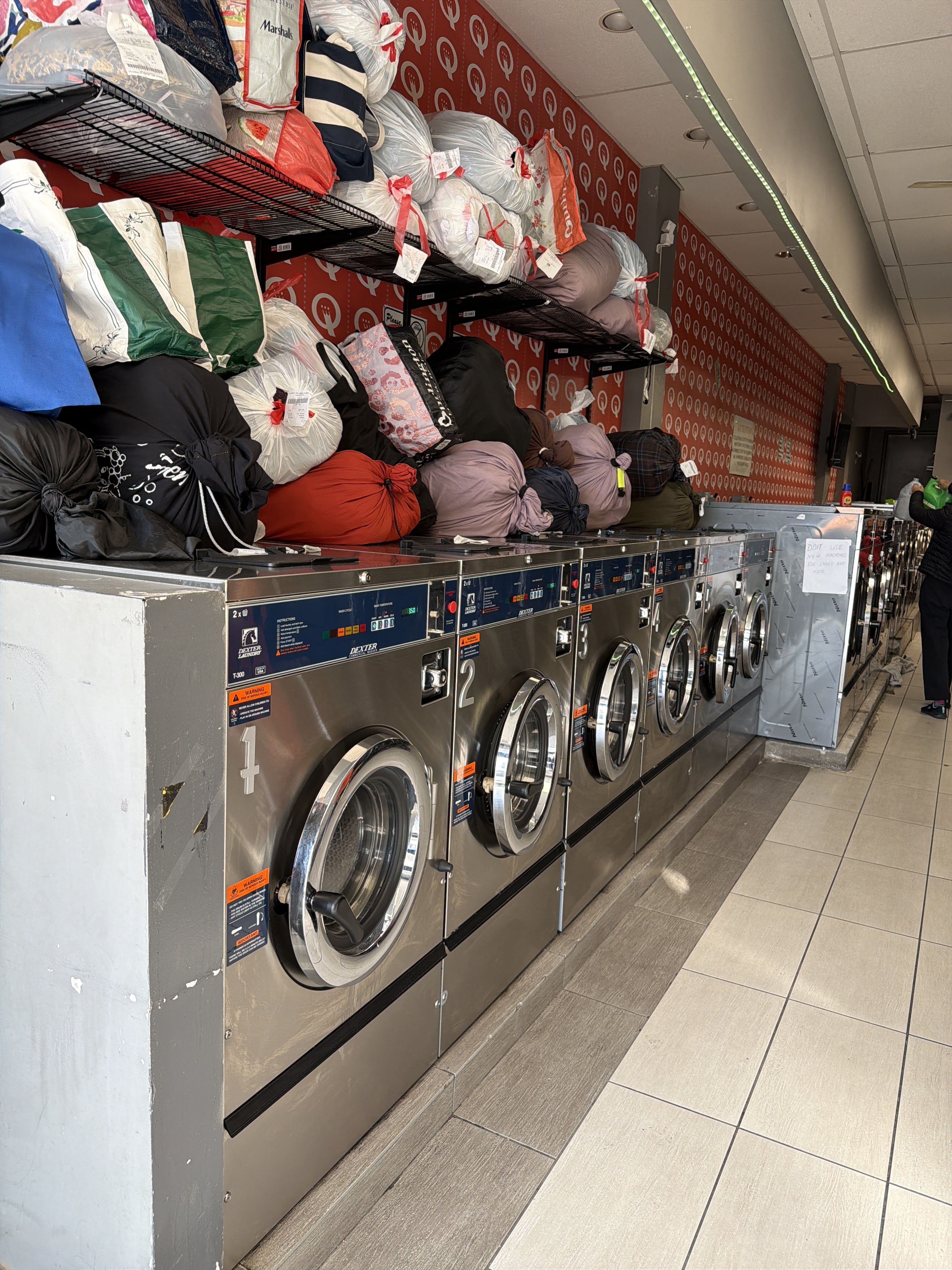 Clean and Green Laundromat facility with washing machines in Queens
