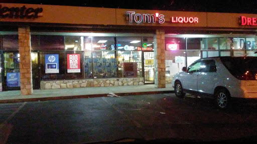 TOMS LIQUOR Logo
