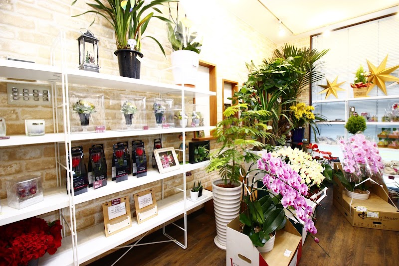 （有）駅前花市