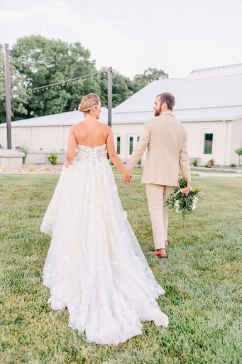Bride in Wedding Dress with her groom in his off white suit purchased from Bridal Traditions Weddin & Prom Attire in North Wilkesboro, NC
