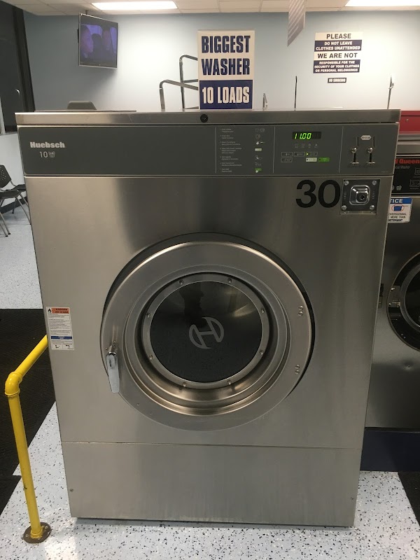 Clean laundry equipment at Coin Laundry Express in Flint, MI