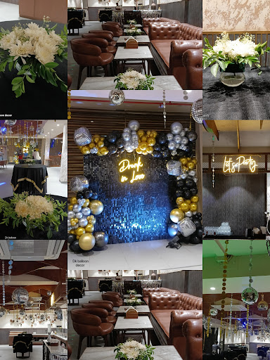 Here's a stunning party decoration setup featuring a glamorous arch of black, gold, and silver ba… post image