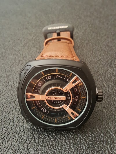 Photos of F. Khan, facing branded retail luxury watches and fancy watches