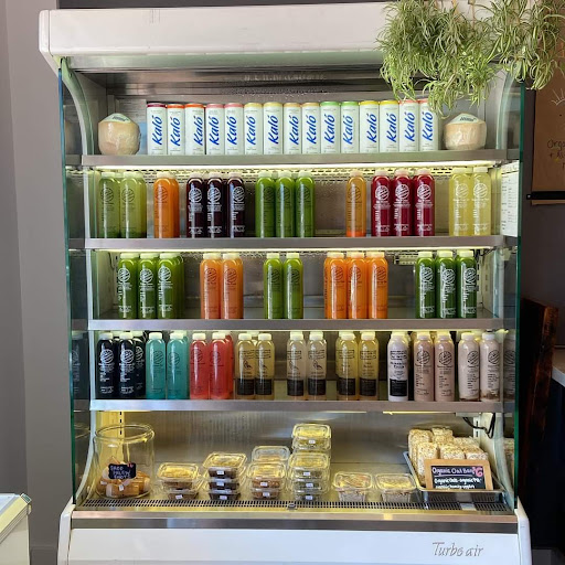 Nourished By Nature Smoothie & Cold Pressed Juice Shop Logo