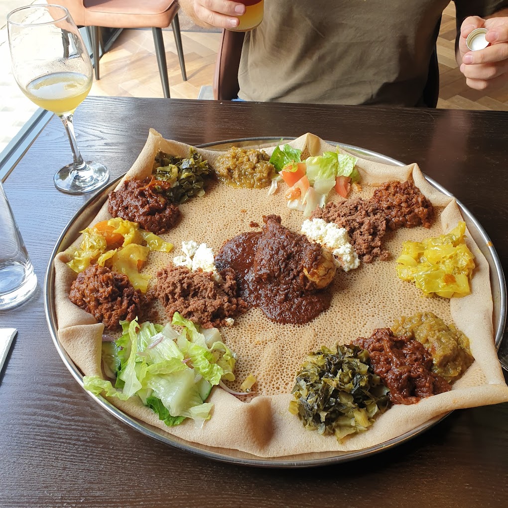 Discover the flavors of Ethiopia in London with our guide to the top Ethiopian restaurants in the city. From traditional stews to vegan options, we've got you covered for a delicious dining experience. #londonfoodguide #londonrestaurants | Places To Eat In London | Ethiopian Restaurants In London | African Restauarants In London | London Food Scene | Unique Places To Eat In London | Quirky Places To Eat In London #london #brixton #camberwell #camden #kentishtown #finsburypark #northlondon