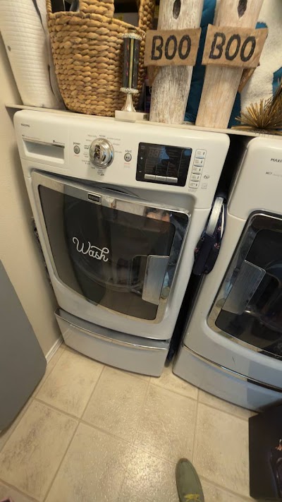 Maytag front-load washer in laundry room