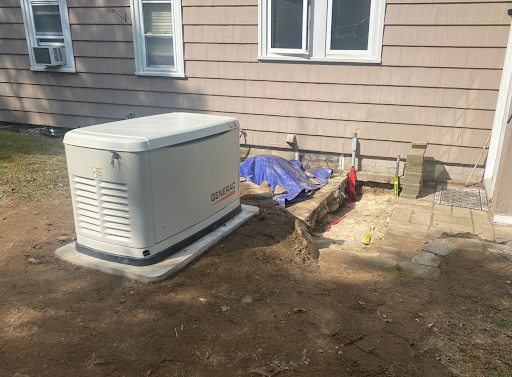 Generac standby generator installation project beside a home in Tewksbury Massachusetts