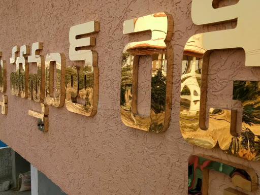 Brass letters fitted on wall .