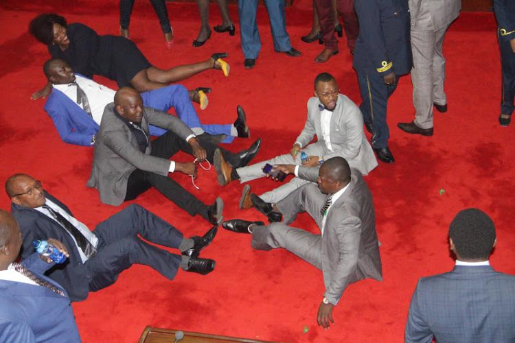 Nairobi MCAs sitting and lying on the floor of the chamber protesting delays of Governor Mike Sonko's administration to release bursary cash.