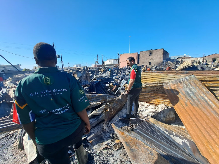 Gift of the Givers personnel onsite at the scene of a fire in Du Noon. Another blaze took the lives of three residents in Masiphumelele.