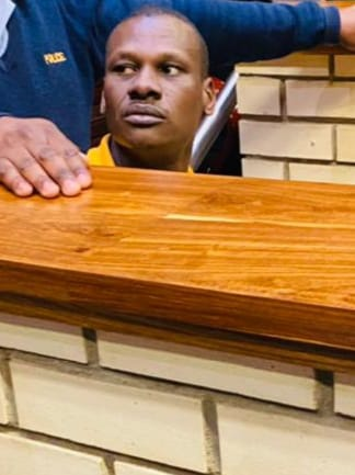 Convicted rapist Prince Thokozane Mazibuko, 34, is led down to holding cells after being sentenced.