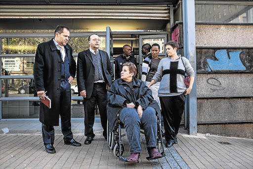 CACHE AND CARRY: Lawyers Modesto Saladino and Larry Marks with Emma Shmukler-Tishko and her daughter Nelly outside the Johannesburg Magistrate's Court yesterday. The Shmukler-Tishko home was raided by the police last week and a cache of illegal weapons and explosives was found