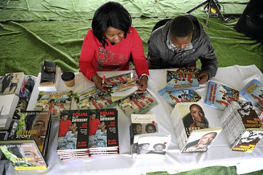 Sibusiso Tshuma, left, and Sakhile Mogale get lost in their own world at Abantu Book Festival in Soweto.